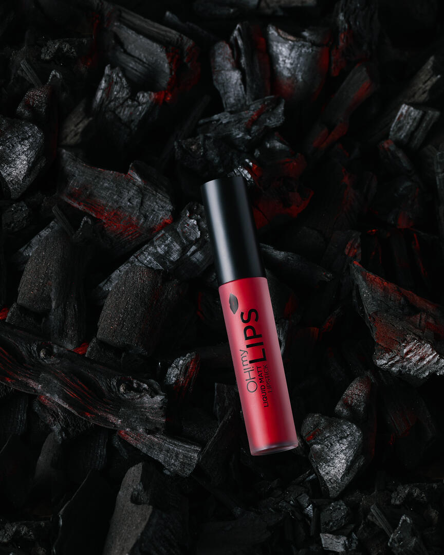 Liquid matte lipstick "Oh my lips" Eveline. Liquid matte lipstick "Oh my lips" Eveline is set on coals that are so hot they still smolder red. This shot is designed to show that this lipstick makes your lips hot, and sexy.