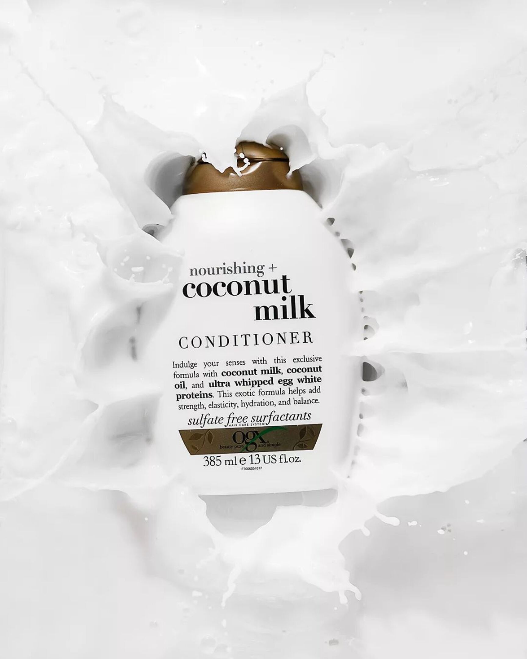 Nourishing Coconut Milk Conditioner - Ogx. The bottle is falling into coconut milk. Splashes are everywhere!