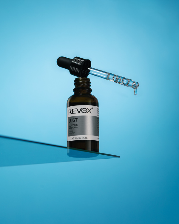 Revox - Just Glycolic Acid 20%. Revox - Just Glycolic Acid 20%. A bottle is on the edge of a glass.