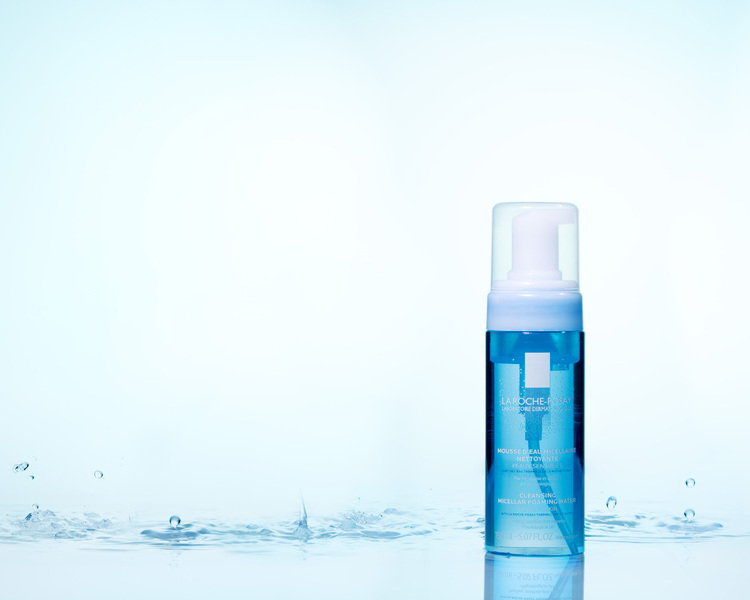 La Roche Posay Mousse. La Roche Posay Mousse. A jar of La Roche Posay Mousse is standing on the water surface, water drops are falling in the background!
