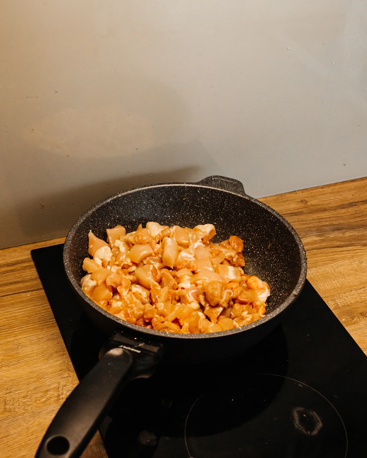 Adding chicken in a pan. 