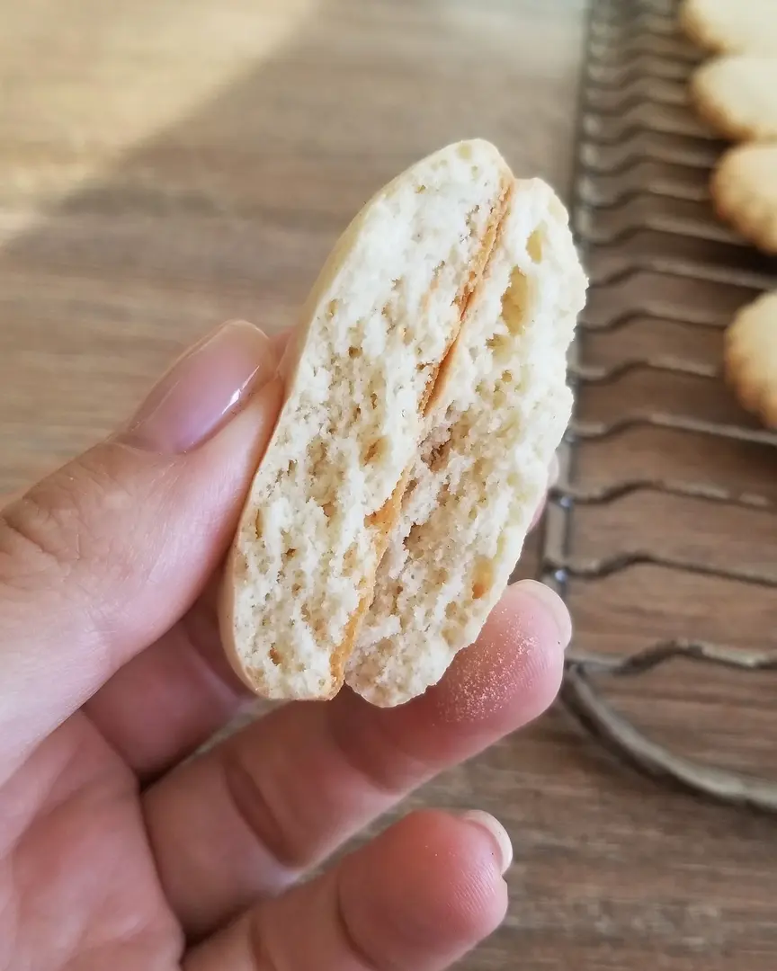  texture of the cookie inside. A woman's hand holding a cookie demonstrates the texture of the cookie inside.