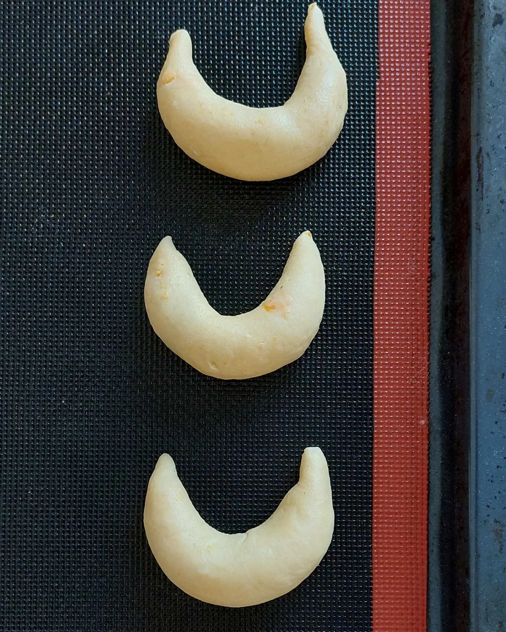 The dough is shaped like crescents. The dough is shaped like crescents.