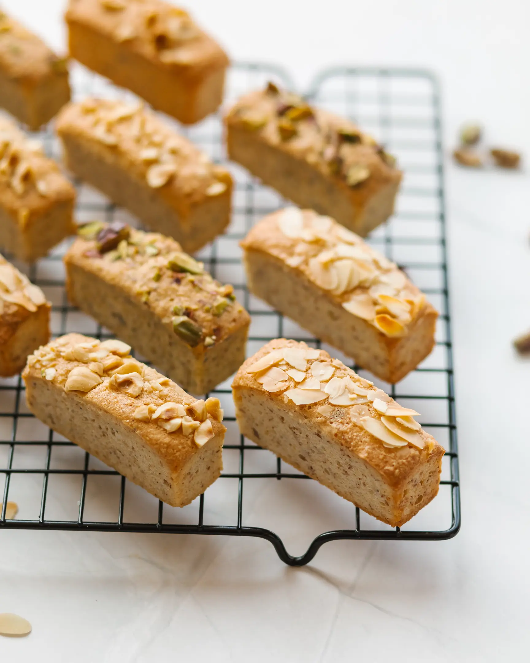 On the bakery tray stands small dessert Financier On the bakery tray stands small dessert Financier