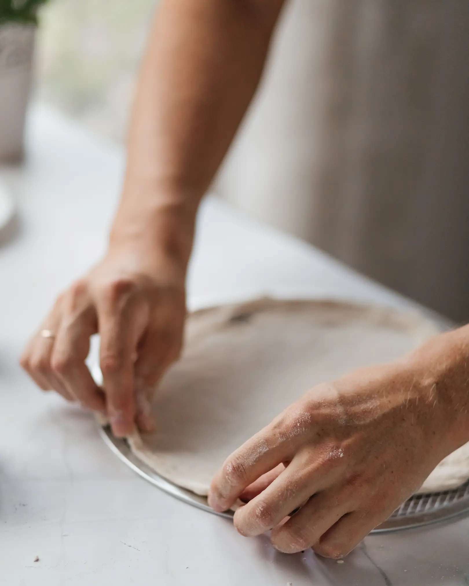 A man adjusts the side of the pizza dough. A man adjusts the side of the pizza dough. The process of making pizza.