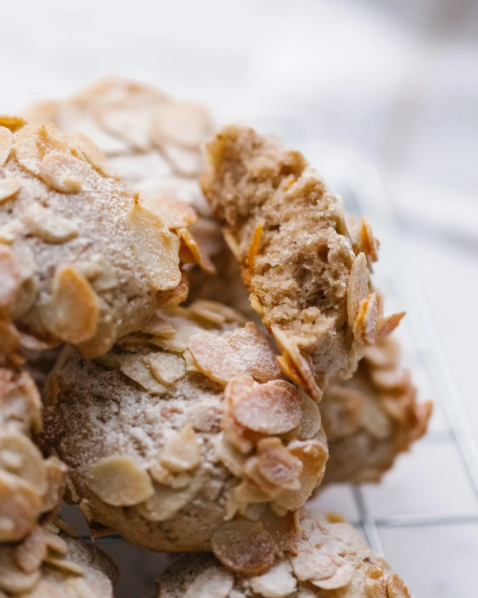 There are walnut biscuits on the table оn a plate. There are walnut biscuits on the table on a plate. One of the cookies is broken - you can see the texture.