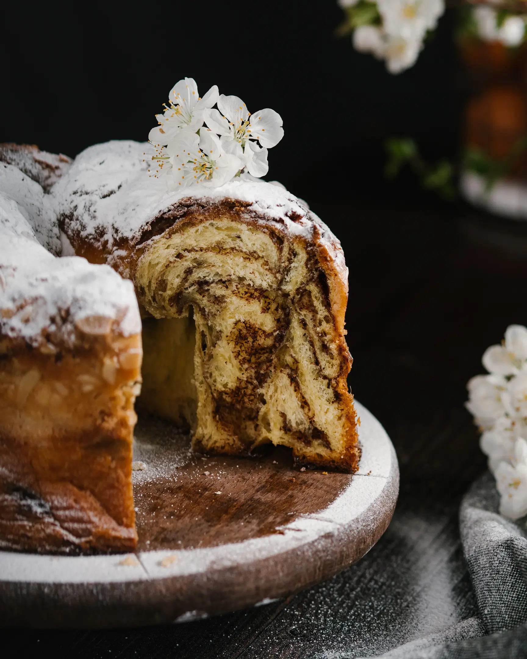 A sliced Easter bread stays on a pastry stand. A sliced Easter bread stays on a pastry stand.