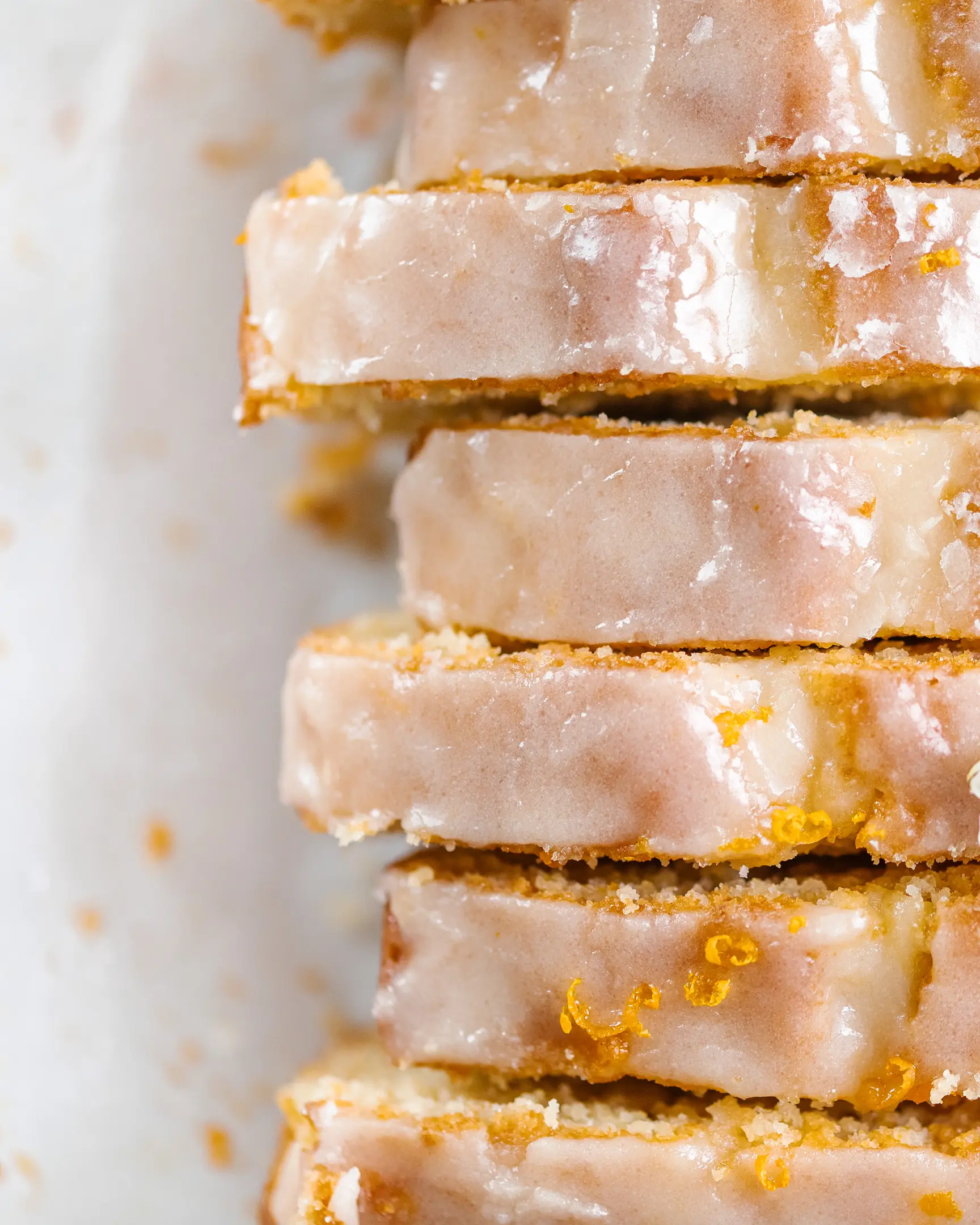 View from above. Orange cake sliced and topped with icing. View from above.