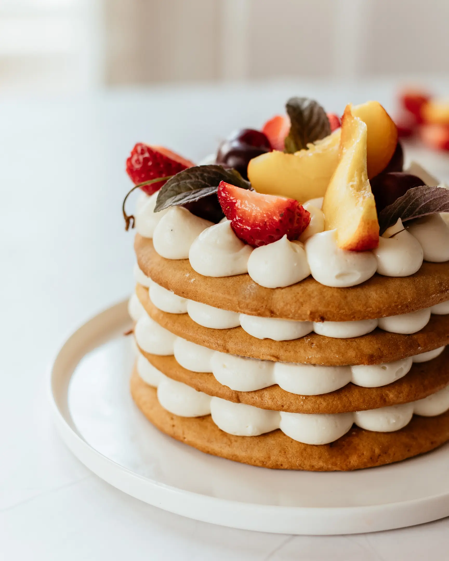 Layered honey cake. Layered honey cake decorated with berries stands on a plate.