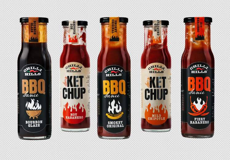 A collection of Chilli-Hills Ketchup. Bottles with Ketchup Chilli-Hills: BBQ Bourbon Glaze, Hot Habanero, Smokey Original, Mild Chipotle, Fiery Habanero.