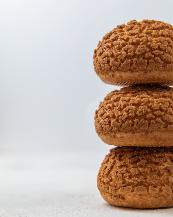 Round eclairs. Round eclairs are on top of each other with a white background.