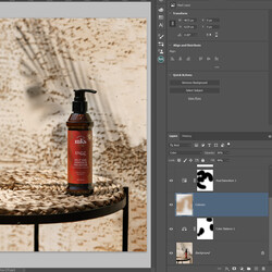 Retouching. Retouching. A photographer uses an Adobe Photoshop application to adjust a photo of a bottle of serum (or shampoo). It is on a table and a shadow of a palm leaf behind it.