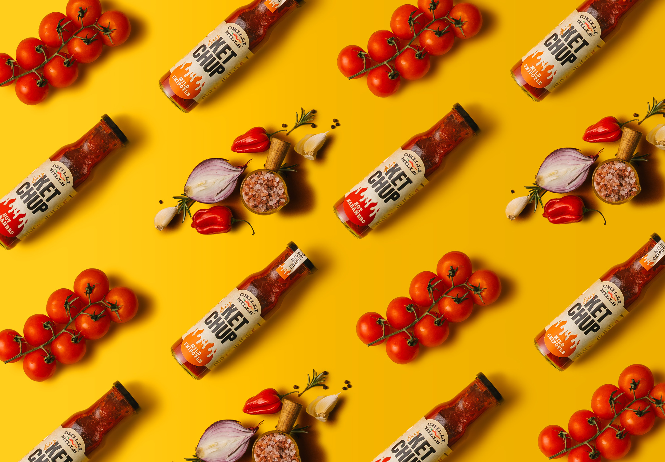 A pattern made of ketchup, peppers, and vegetables. On a yellow background, ketchup bottles, together with peppers, onion, garlic, tomatoes, and salt, form a pattern.