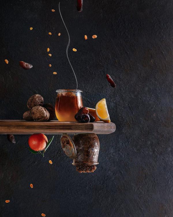 Levitation: Nuts, Orange, Jar of Honey, Lemon, Fruits. Levitation: Nuts, Orange, Jar of Honey, Lemon, Fruits. Nuts are flying in the air around a jar of honey. Orange, lemon, jar with jam, fruits - everything is upside down! That's just impossible!