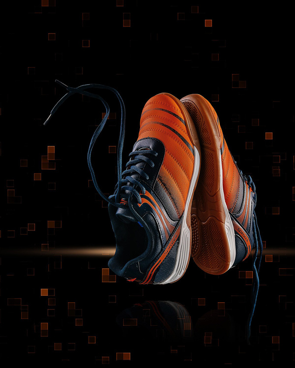 Sneakers And Digital Effect Sneakers And Digital Effect On a dark background, traces of pixel clustering are visible. Such dots remind the viewer of the movie The Matrix. In the foreground are orange and blue sneakers. They seem to hang in the air, and the laces are directed upwards.